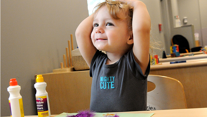 Small kid with hands over their head